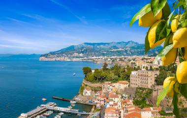 Aerial presumption    of cliff coastline Sorrento and Gulf of Naples, Italy. Ripe yellowish  lemons successful  foreground. In Sorrento lemons are utilized  successful  accumulation   of limoncello.