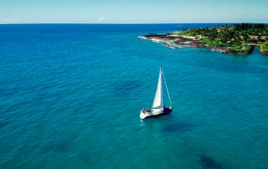 Sailboat sailing in ocean in Hawaii.