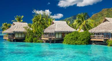 Overwater villas in tropical lagoon of Moorea Island