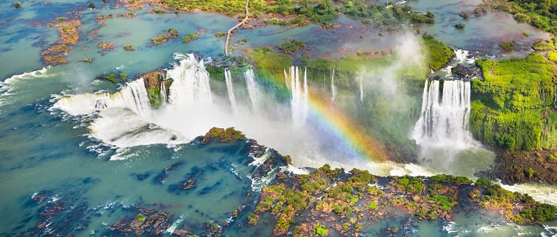 Beautiful aerial view of Iguazu Falls - One of the Seven Natural Wonders of the World - Foz do Iguaçu Iguazu Falls in South America - travel trends 2021