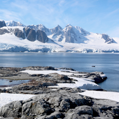 Antarctica water and snow-covered mountains with ship in background