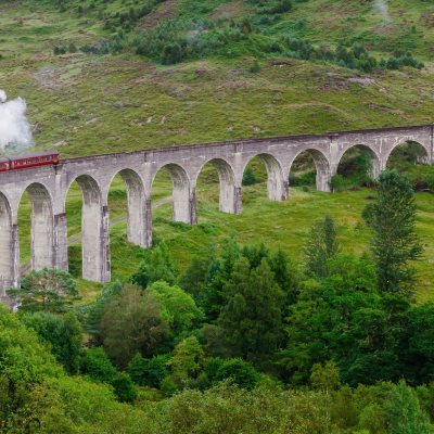 Jacobite steam train on Glenfinnan Viaduct approaching, Highlands, Scotland, United Kingdom, Europe
