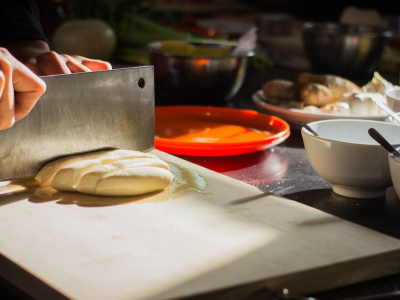 a person preparing food in a bowl on a table