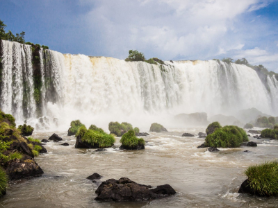a large waterfall over a body of water