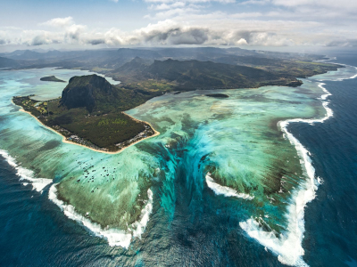 a body of water with a mountain in the background