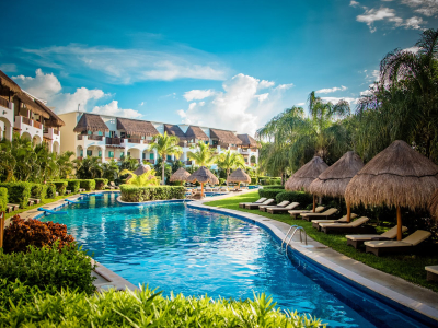 a group of lawn chairs sitting next to a pool of water