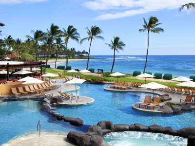 a group of people sitting on a dock next to a body of water