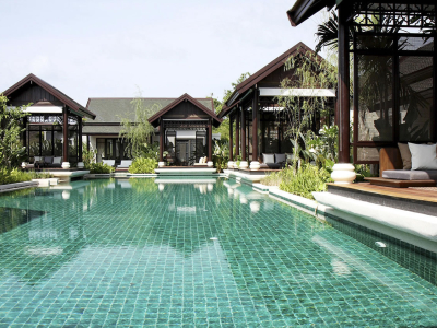 a house with a pool in front of a building