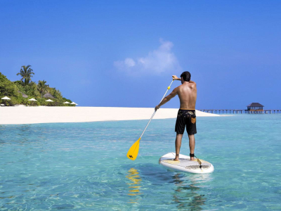 a man standing next to a body of water