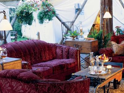 a living room filled with furniture and vase of flowers on a table
