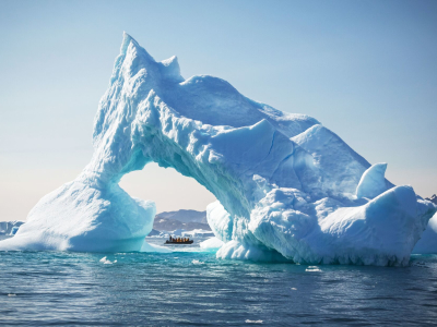 a large body of water with a mountain in the background