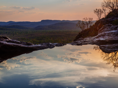 a body of water with a mountain in the background