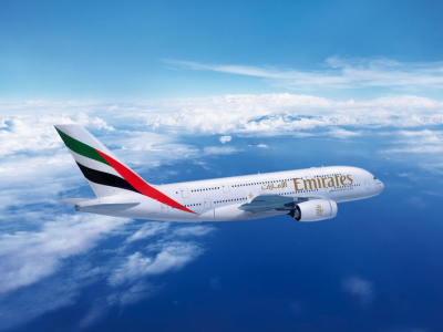a large passenger jet flying through a cloudy blue sky