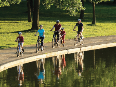 a group of people riding bikes down a river