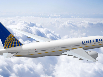 a large passenger jet flying through a cloudy blue sky