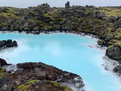 A beautiful blue lagoon surrounded by green covers
