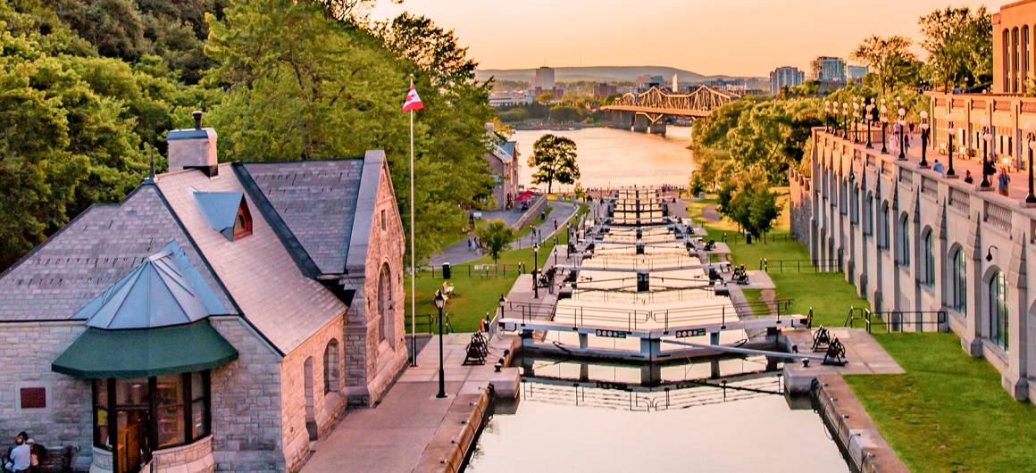 Traditional cottages and boathouses line a small island along the Rideau Canal, blending rustic charm with Canadian heritage.