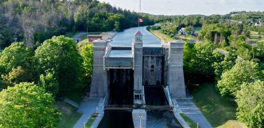 Aerial view of the Trent‑Severn Lift Lock canal in Ontario, surrounded by greenery and clear skies on a summer day.