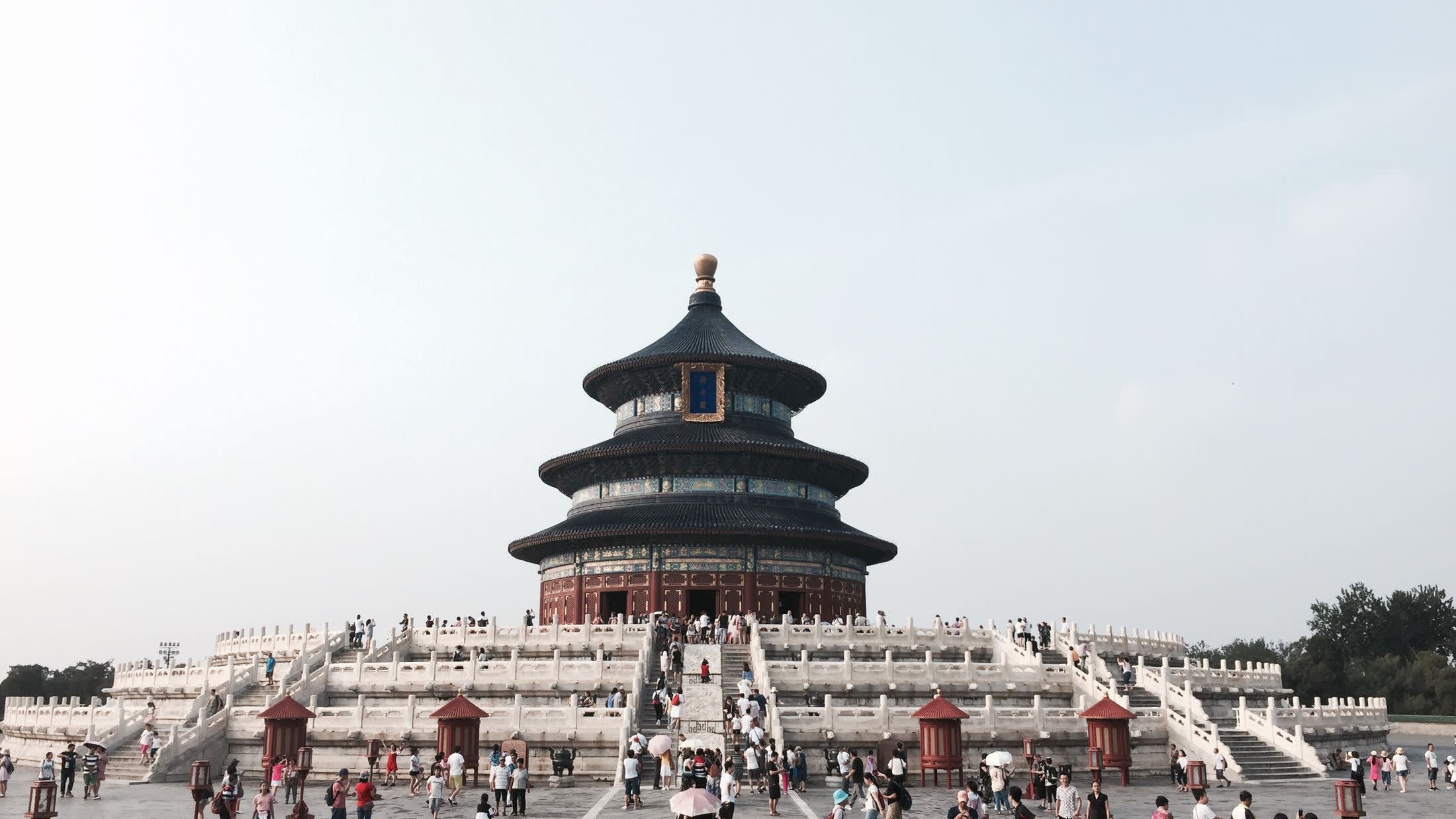 a group of people standing in front of Temple of Heaven