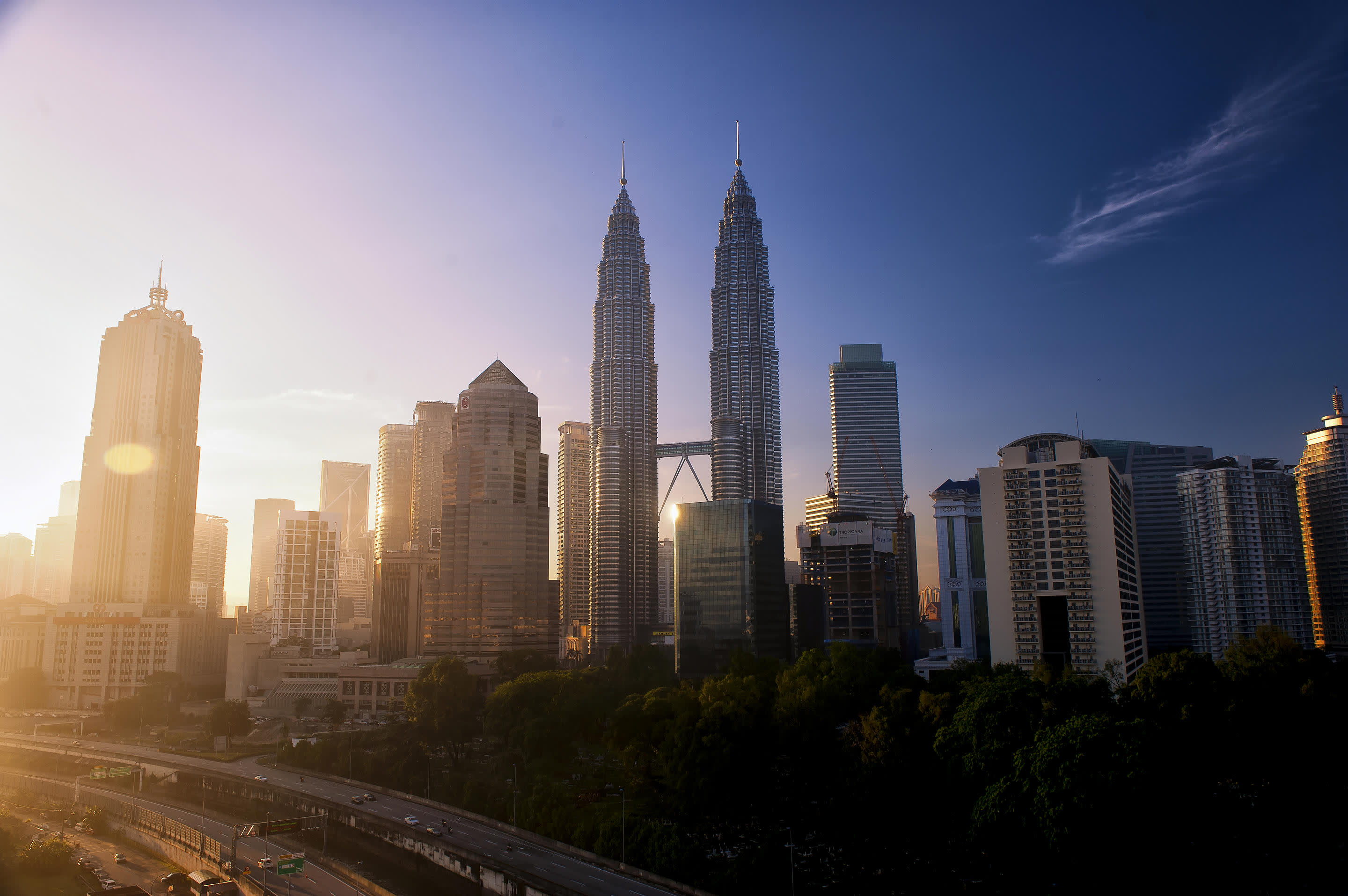 a view of Petronas Towers with tall buildings