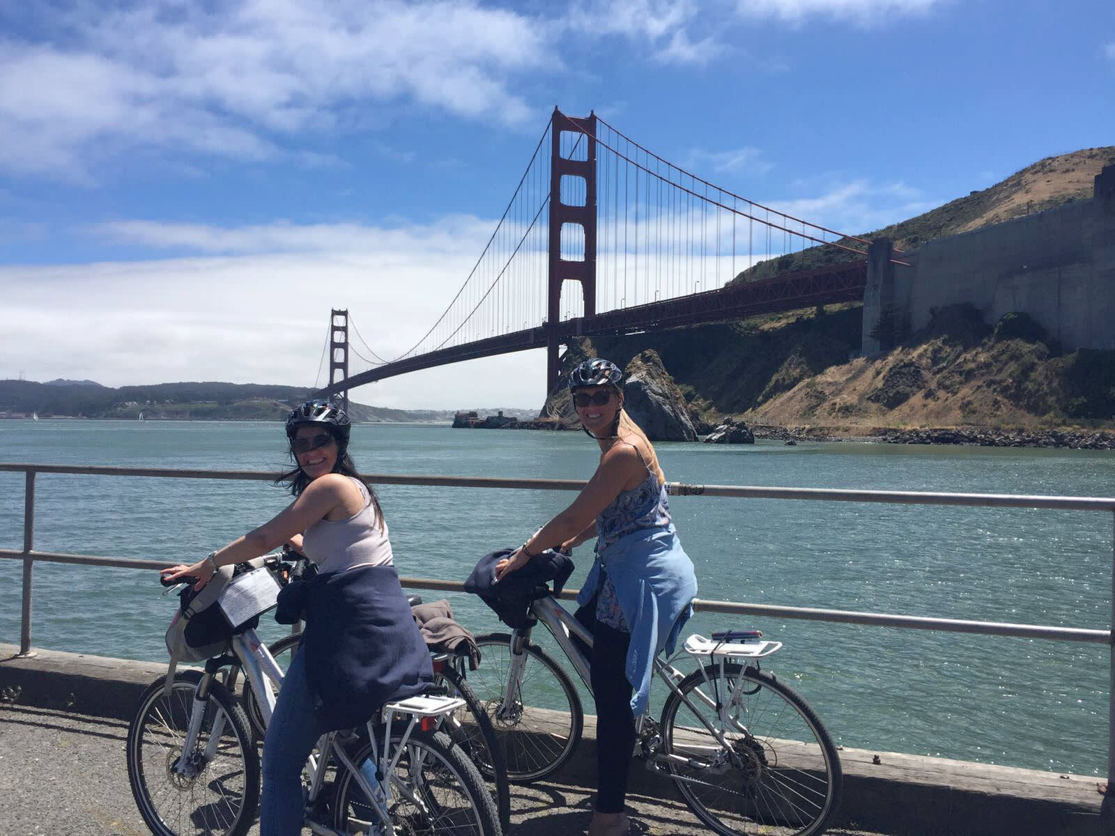 a person riding a bicycle next to a body of water