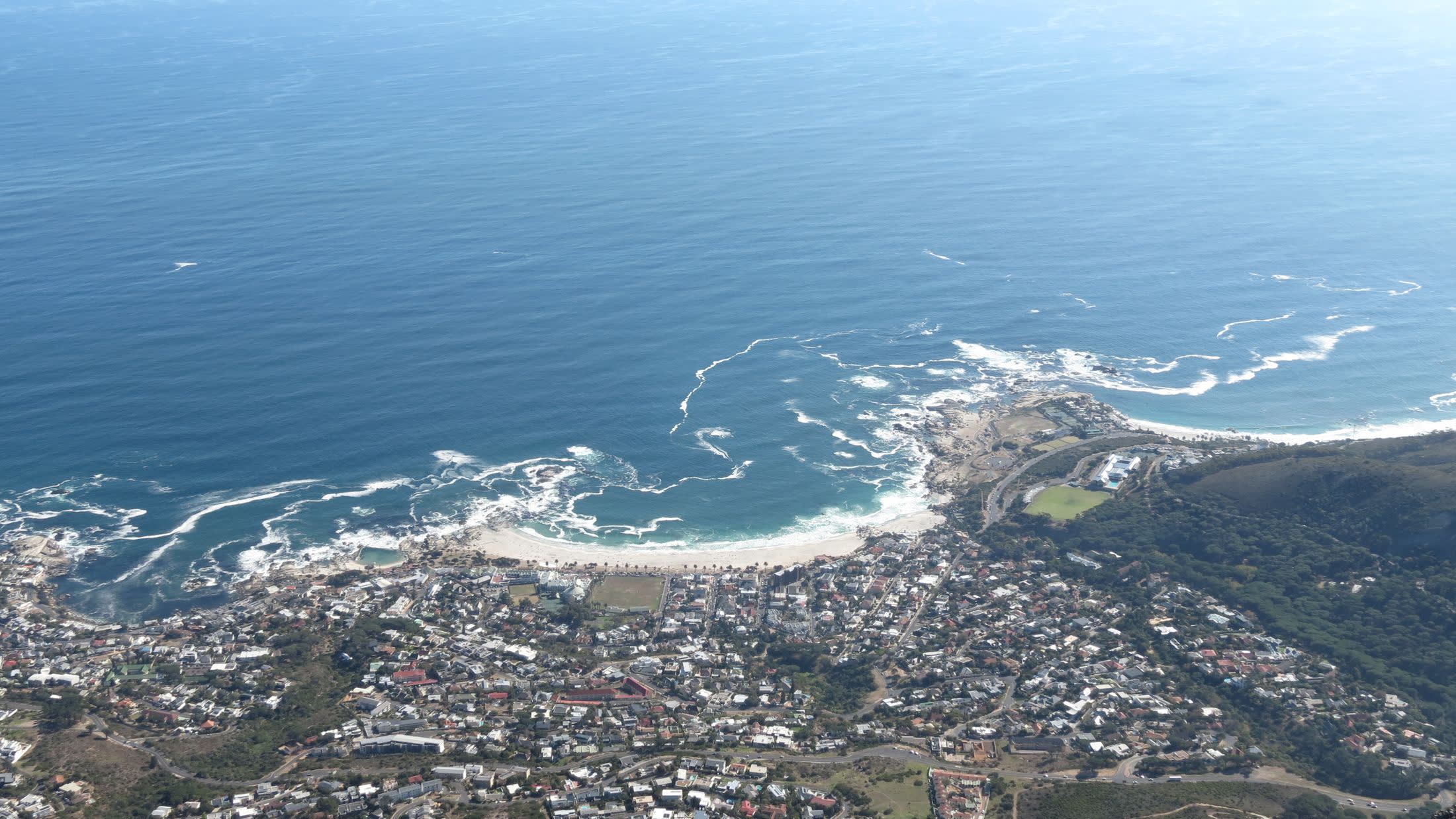 a large body of water with a mountain in the background