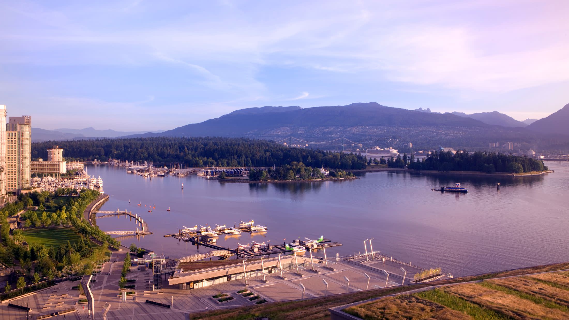 a bridge over a body of water with a city in the background