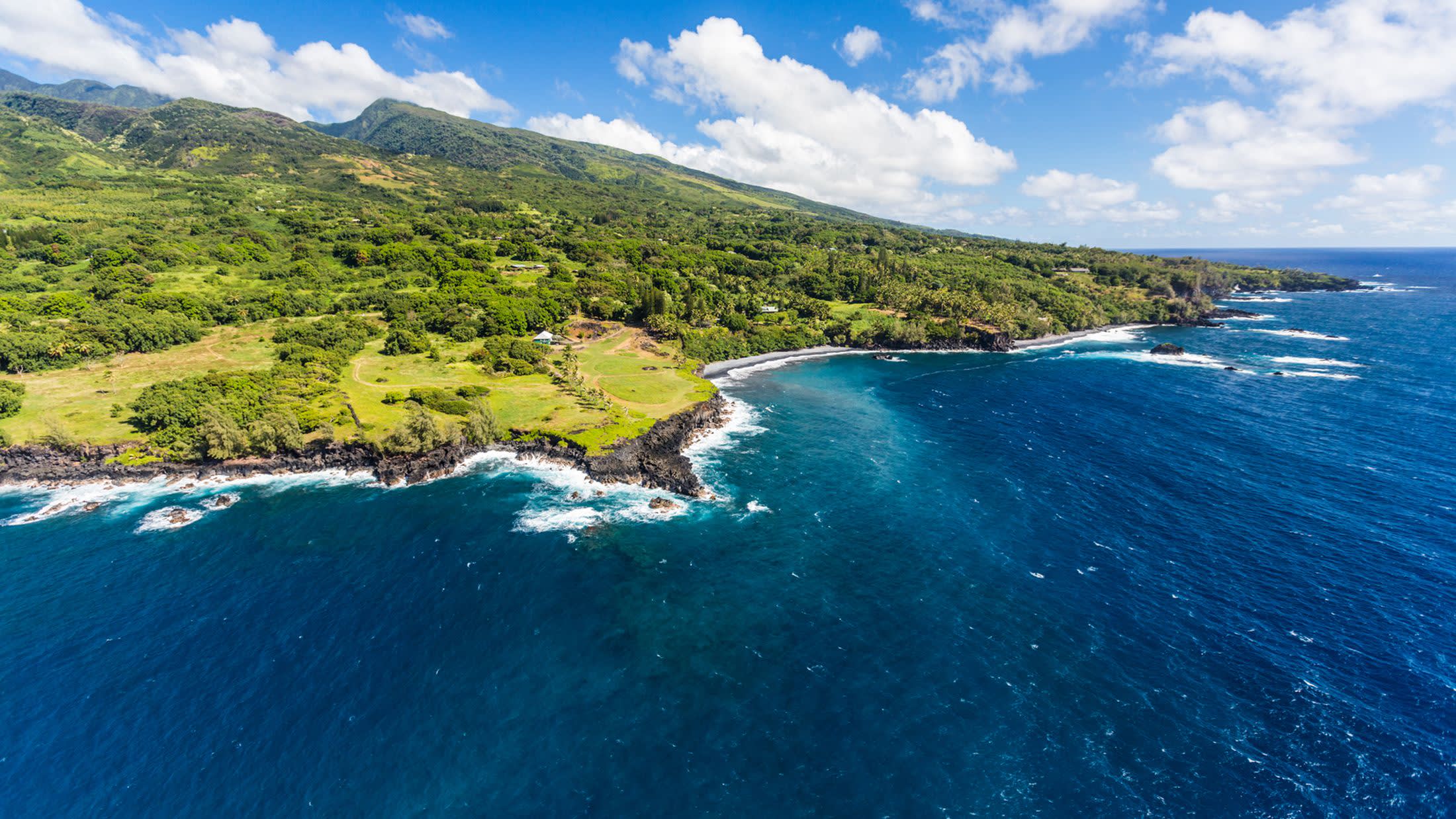 a large body of water with a mountain in the background