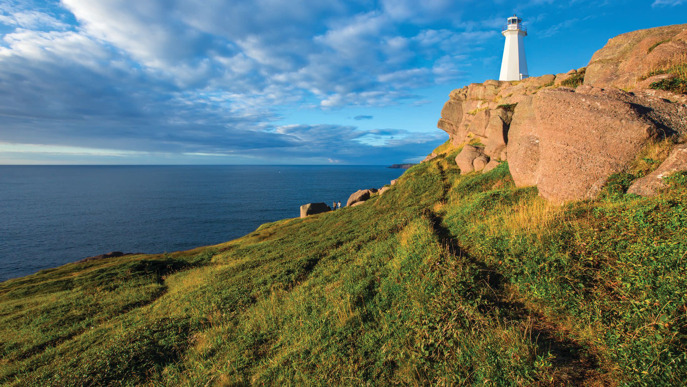 a rocky island in the middle of a grassy hill