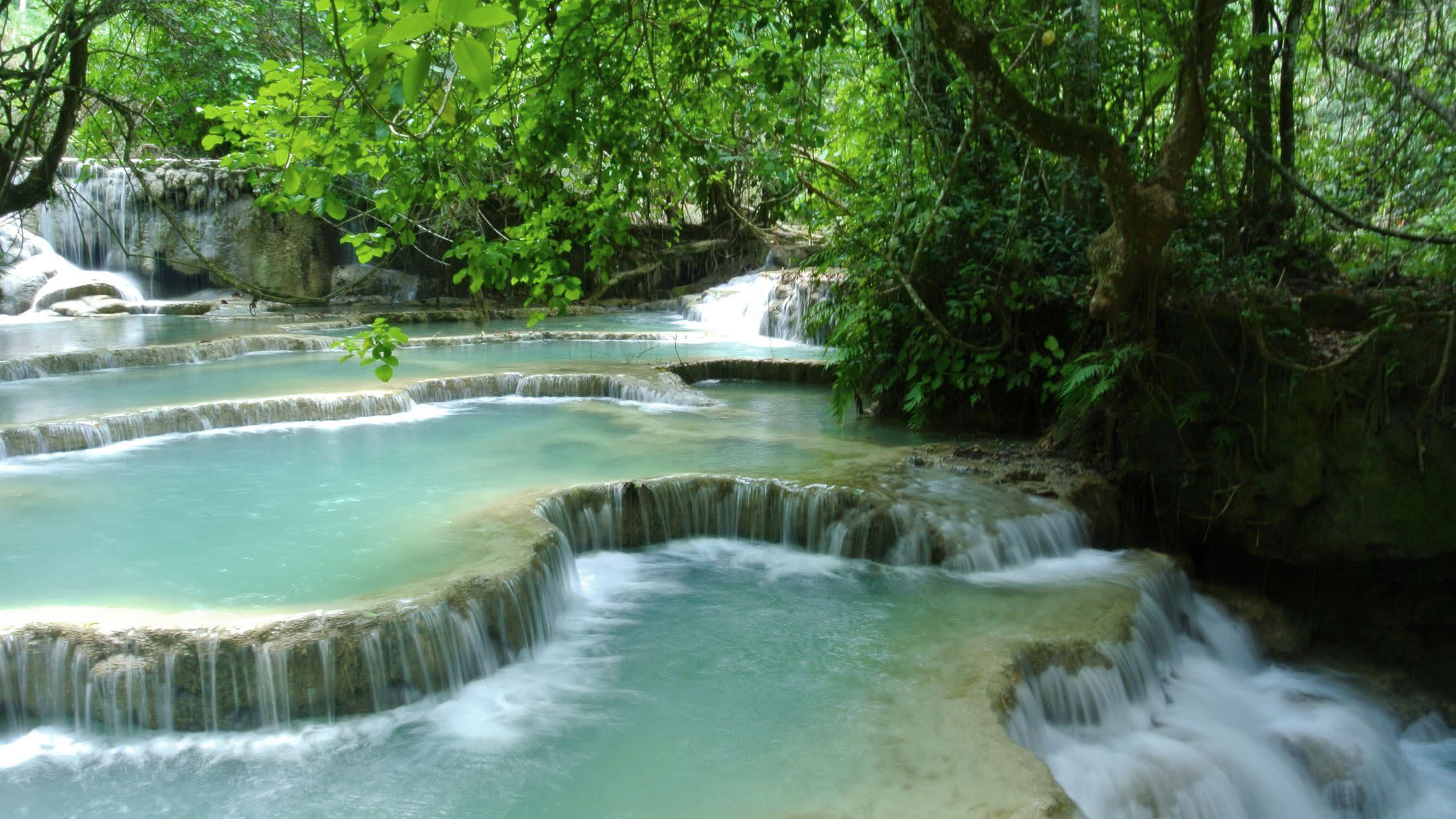 a large waterfall and a pool of water