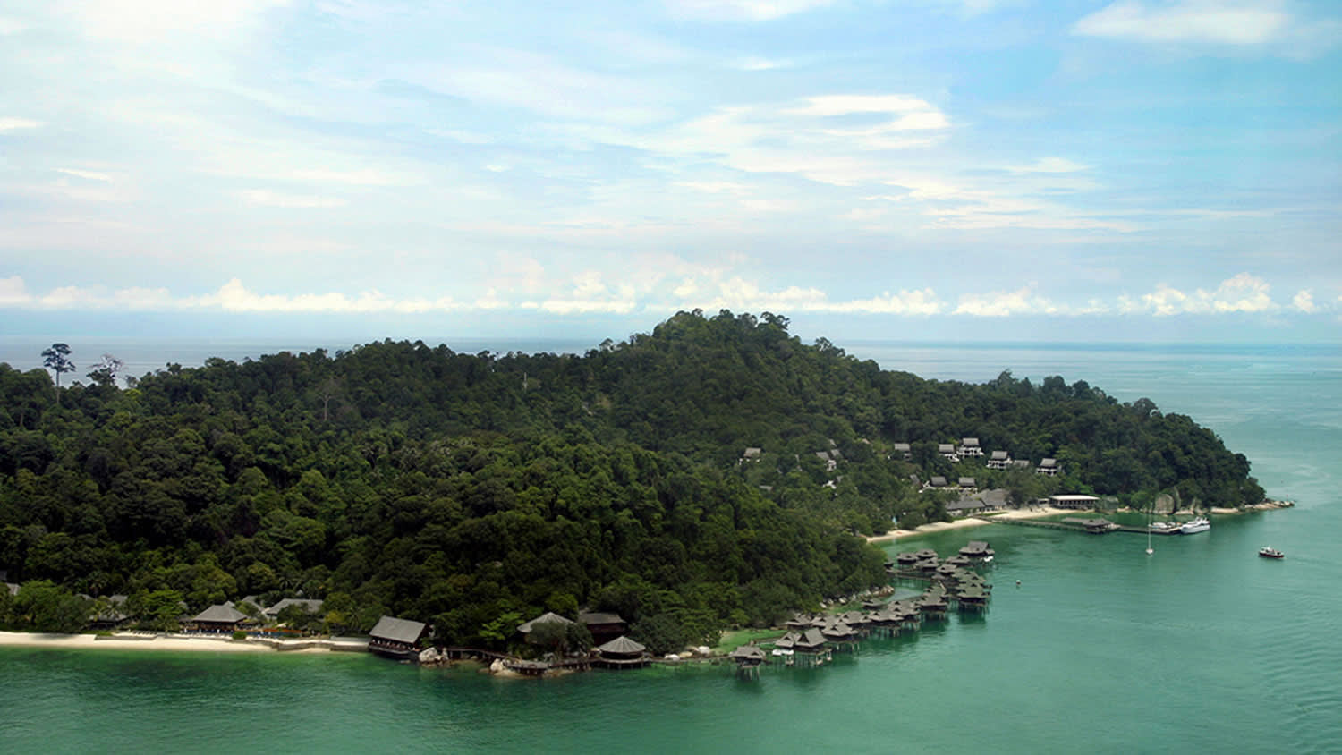 a small boat in a body of water surrounded by trees