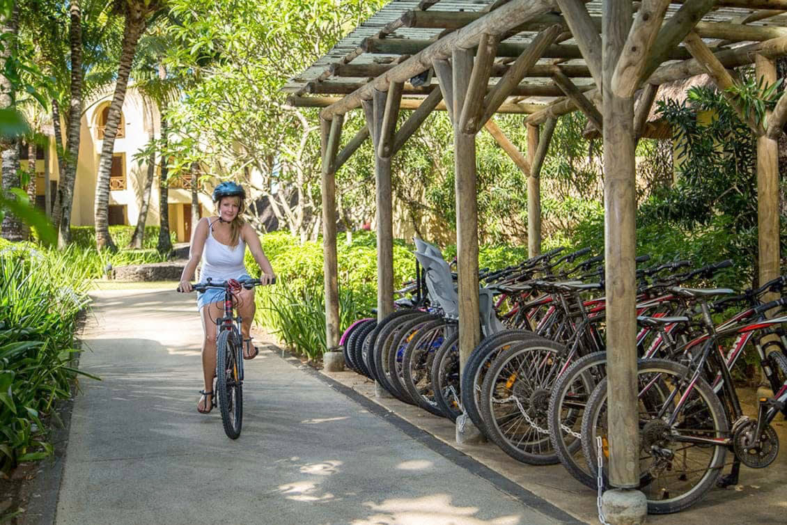 a group of people riding on the back of a bicycle
