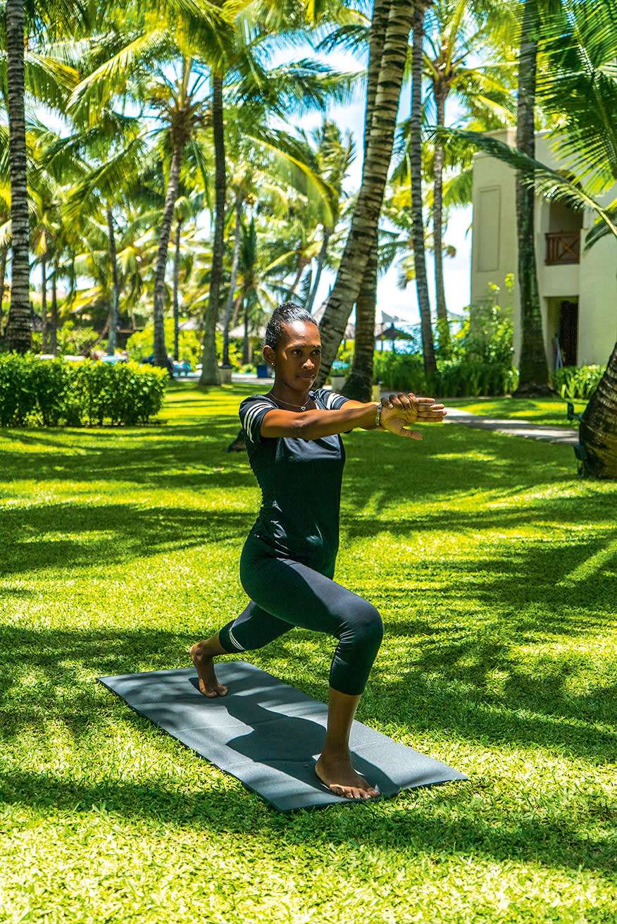 a person holding a frisbee in the park