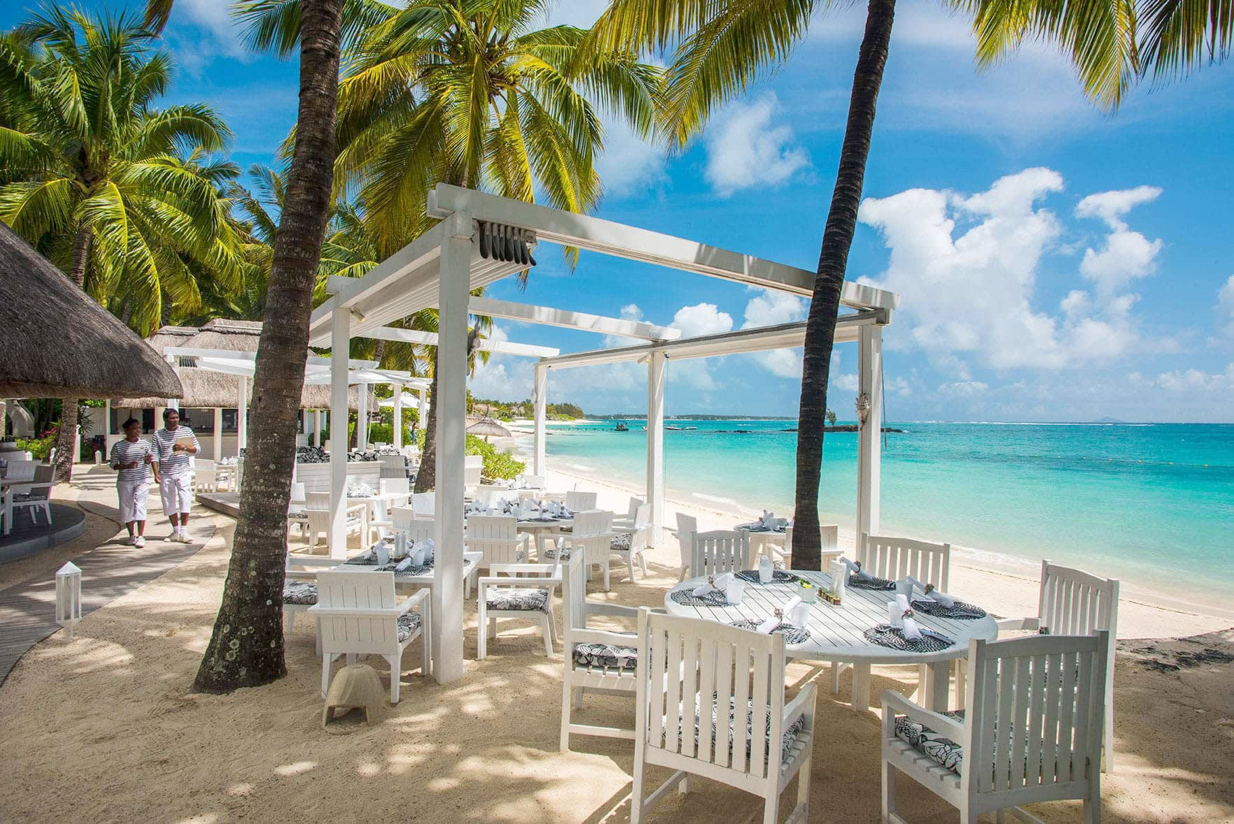 a couple of lawn chairs sitting on top of a beach