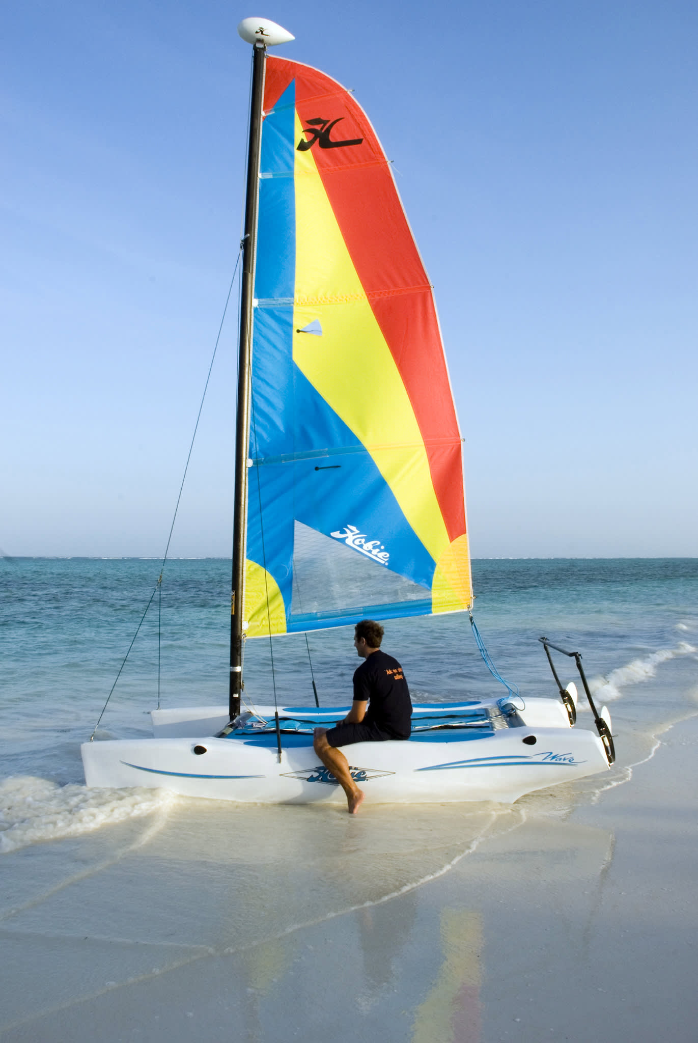 a man riding on the back of a boat in the water