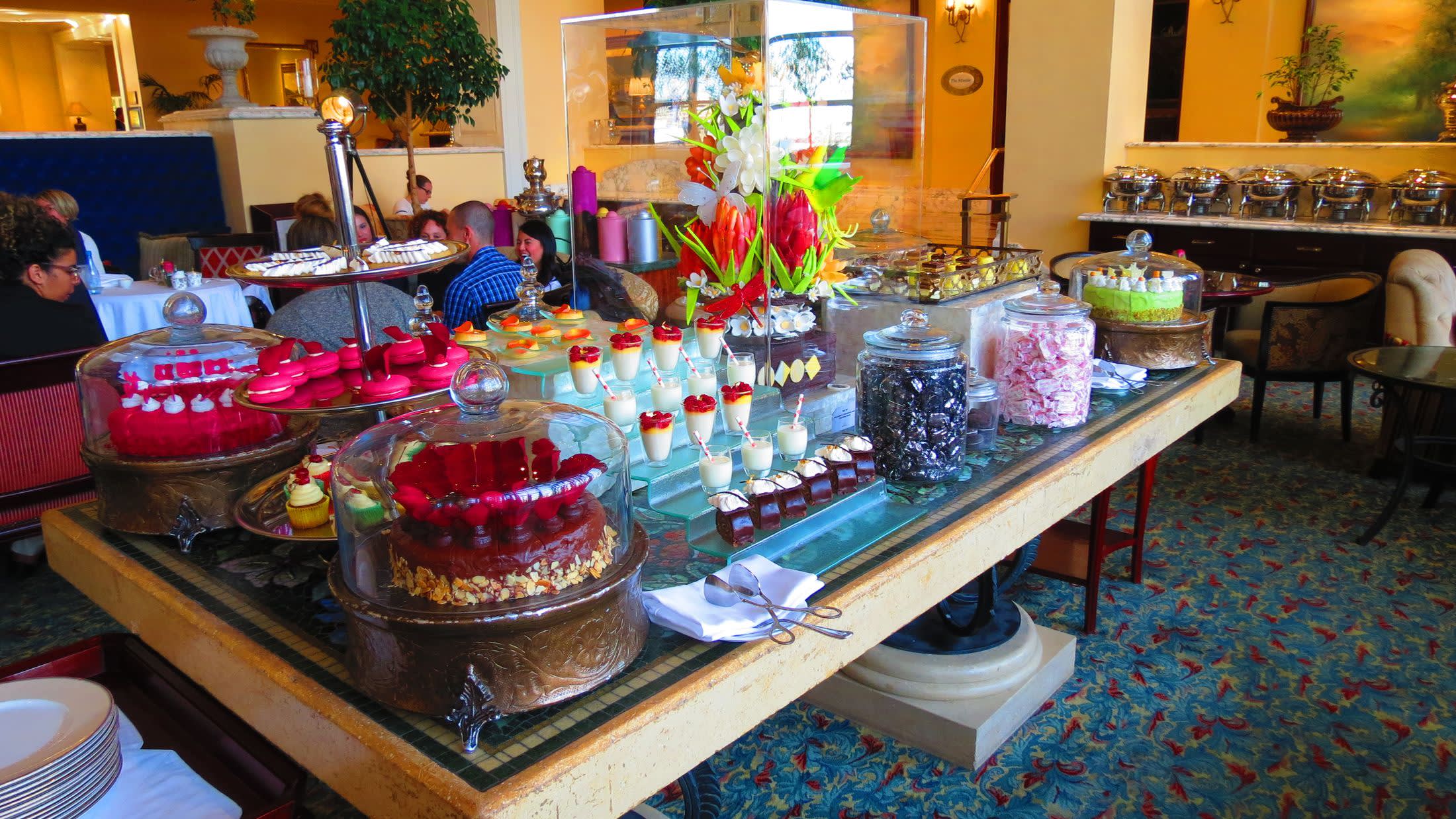 a person sitting at a table with a cake