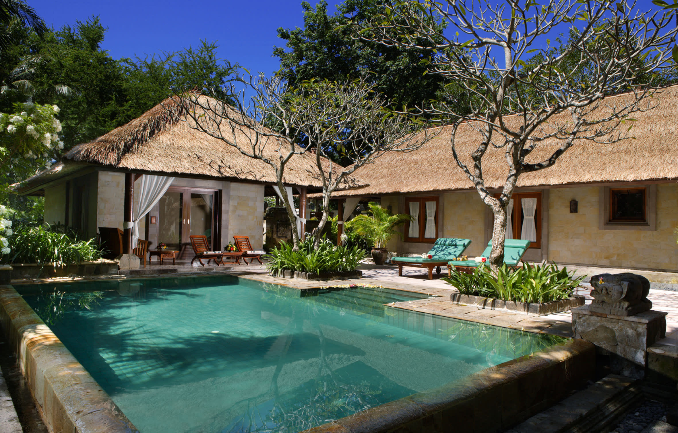 a house with a pool in front of a building