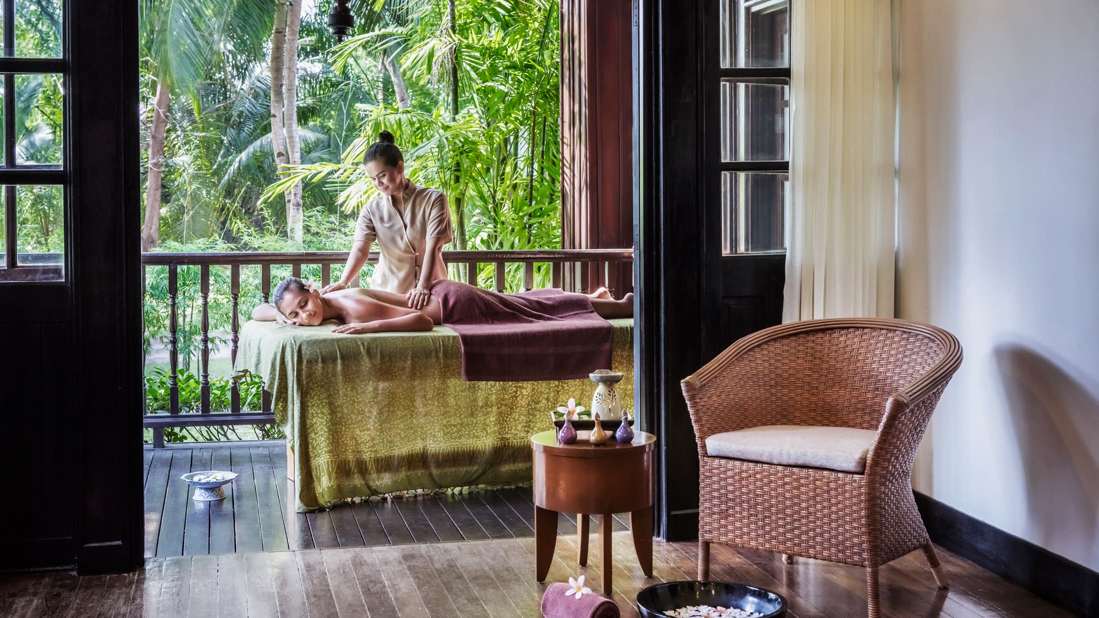 a person sitting on a chair in front of a window
