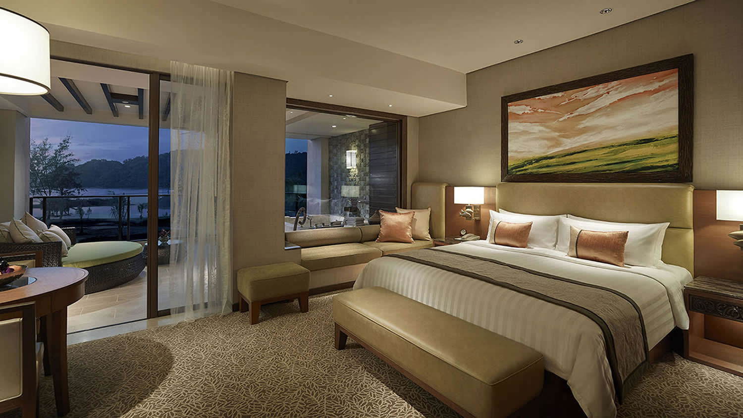 a bedroom with a bed and desk in a hotel room