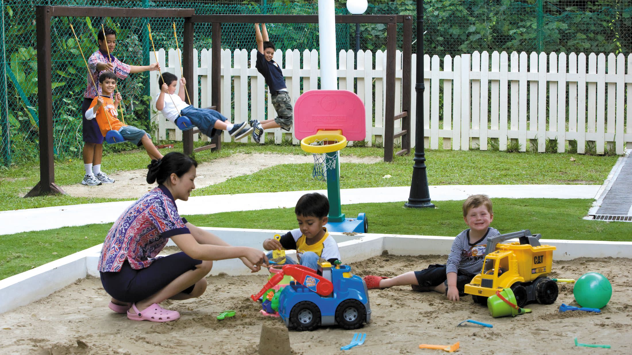 a small child sitting on a bench in a park