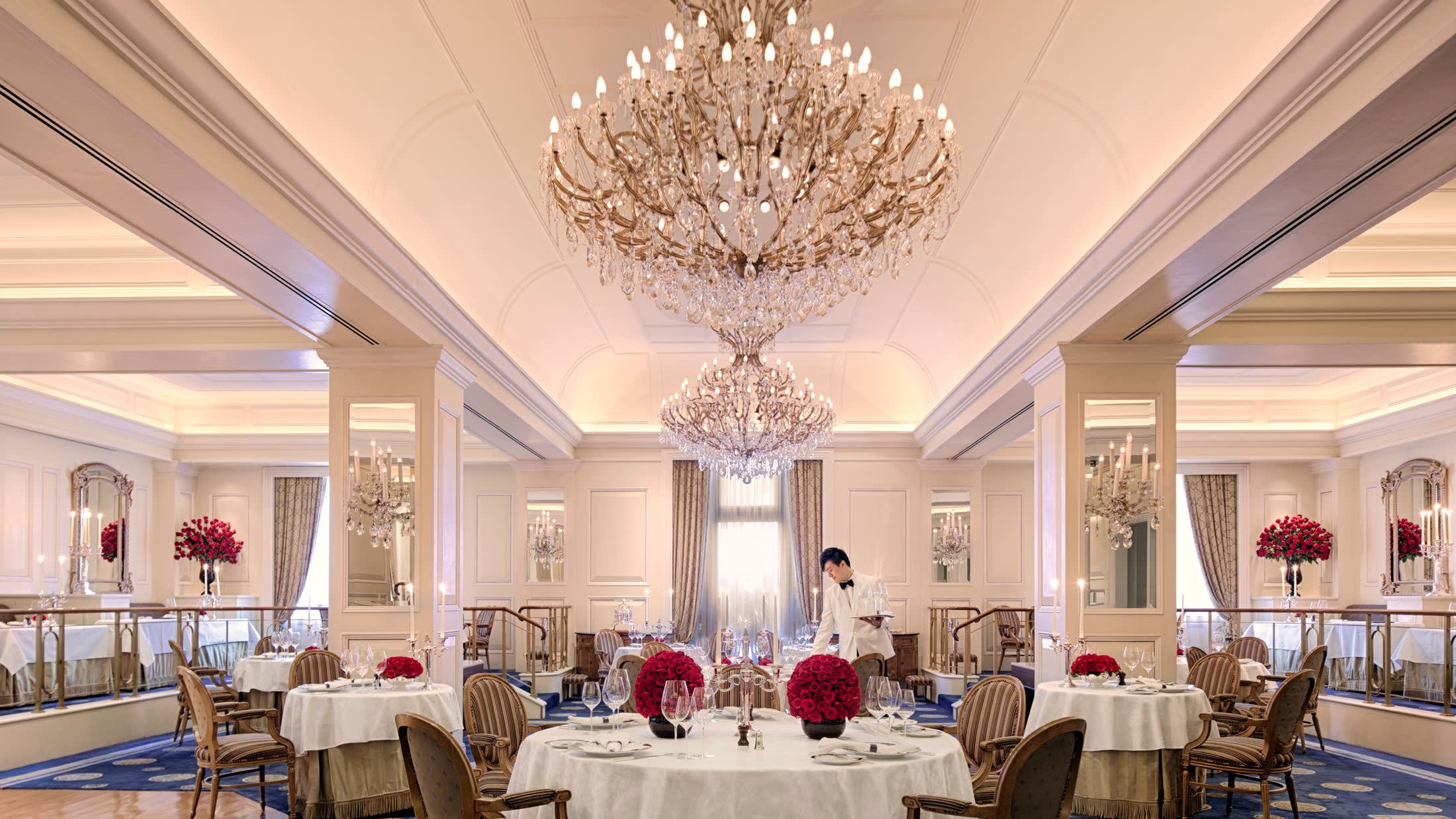 a living room filled with furniture and vase of flowers on a table