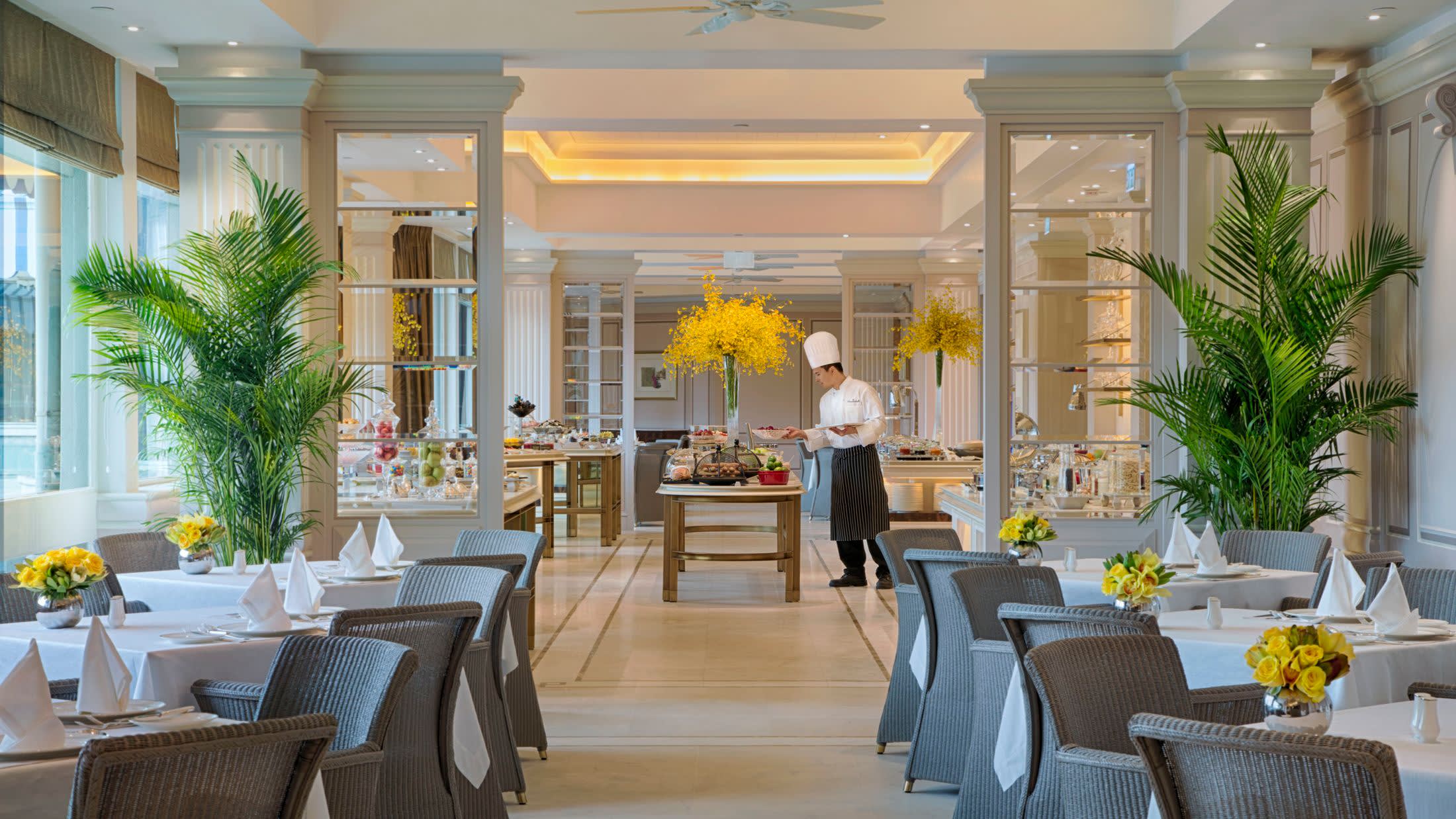 a living room filled with furniture and vase of flowers on a table