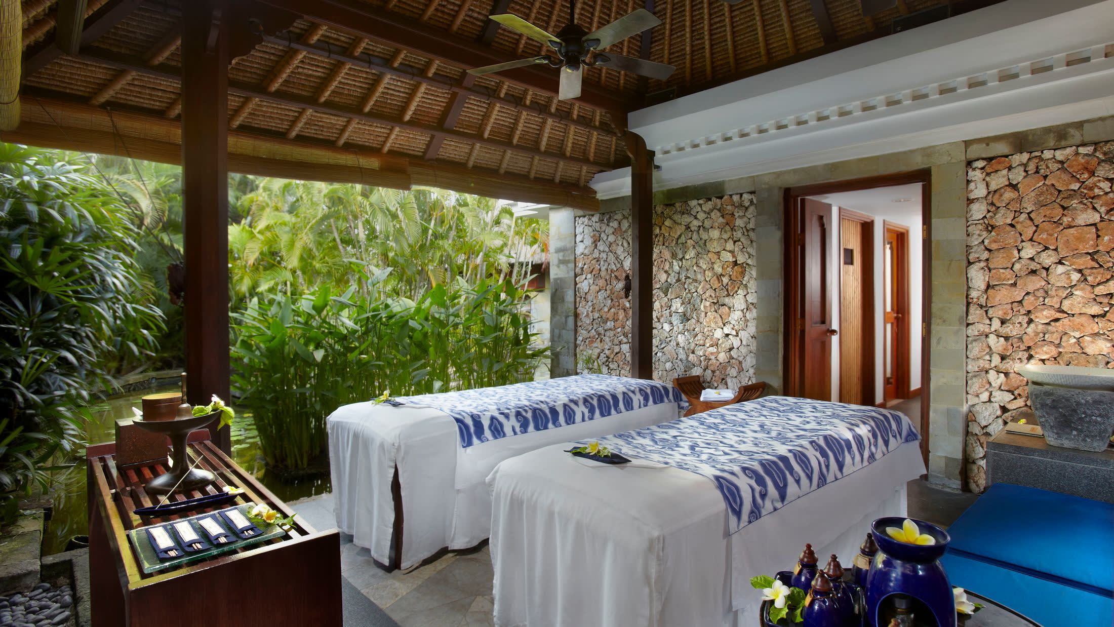 a bedroom with a bed and a chair in a room