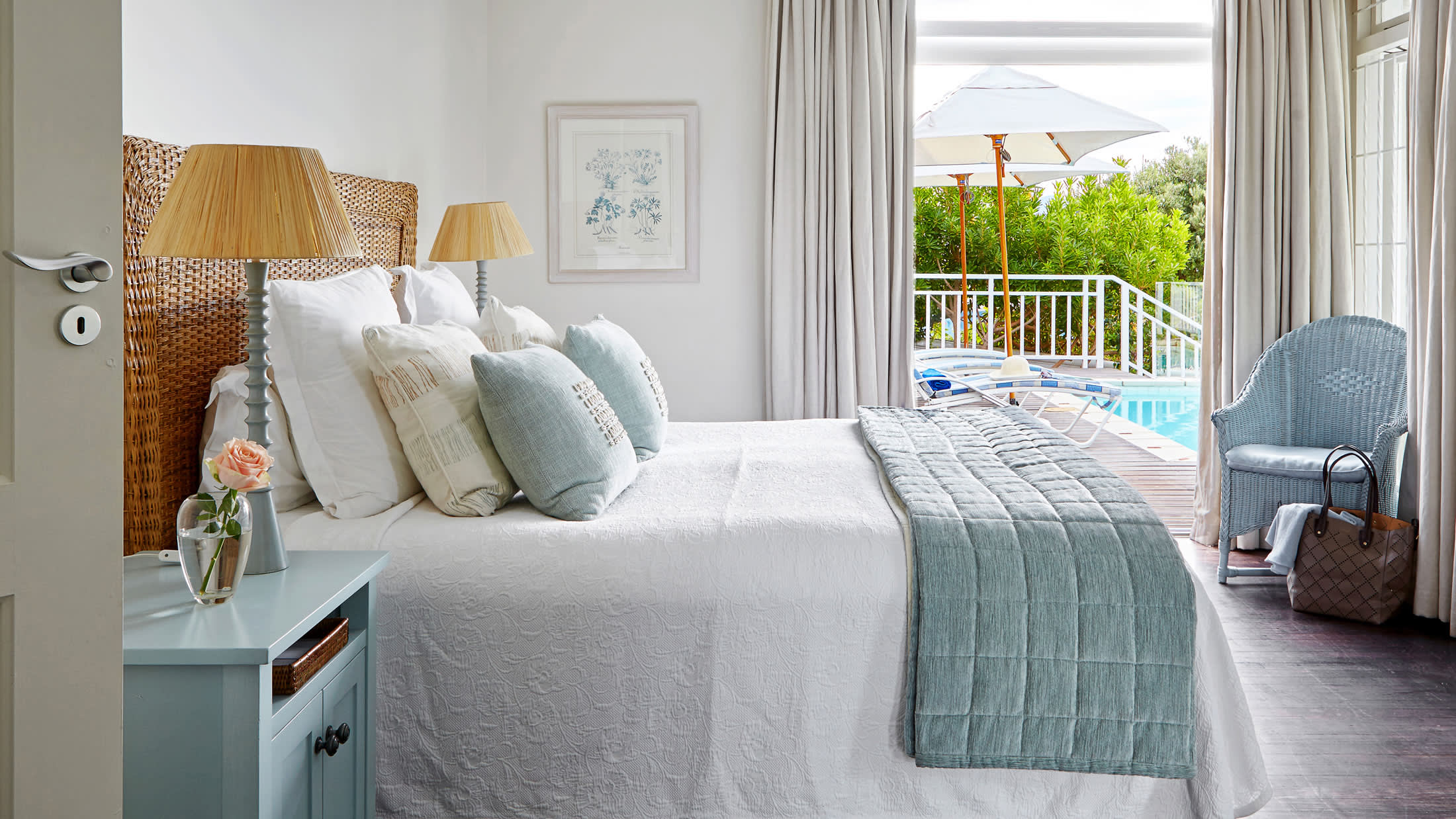 a bedroom with a bed and a chair in a room