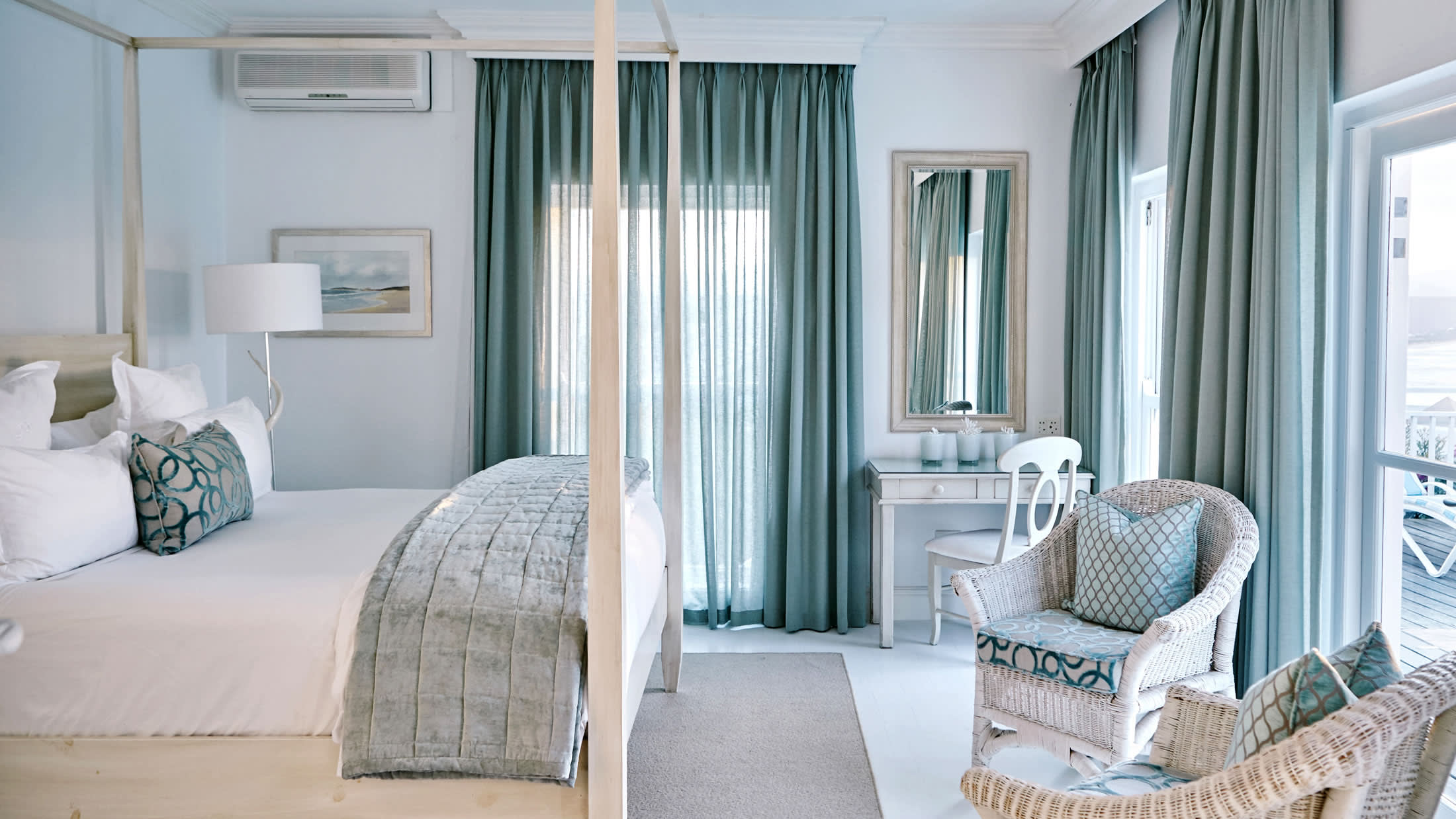 a bedroom with a bed and a chair in a room