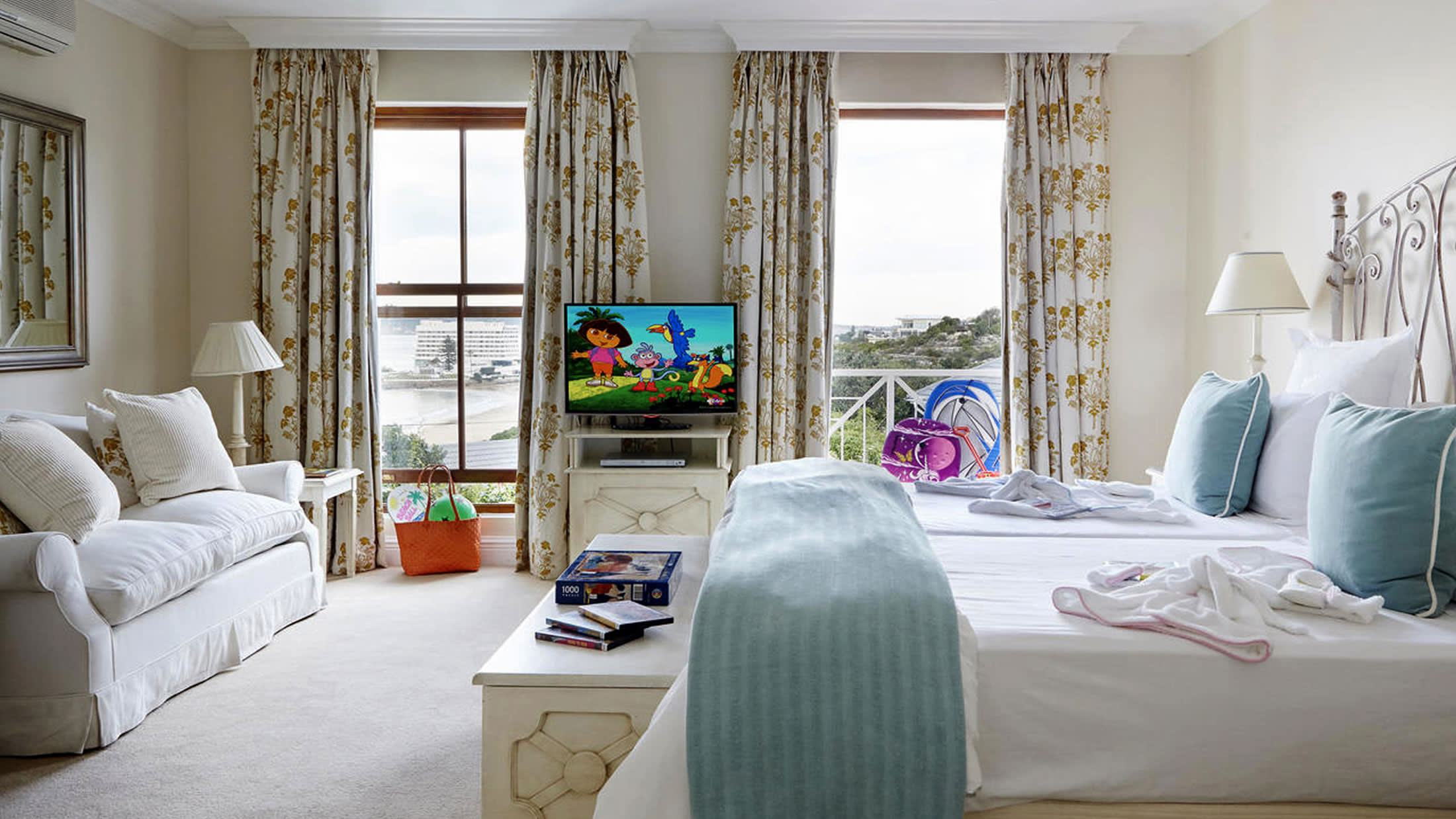 a living room with a bed and a window