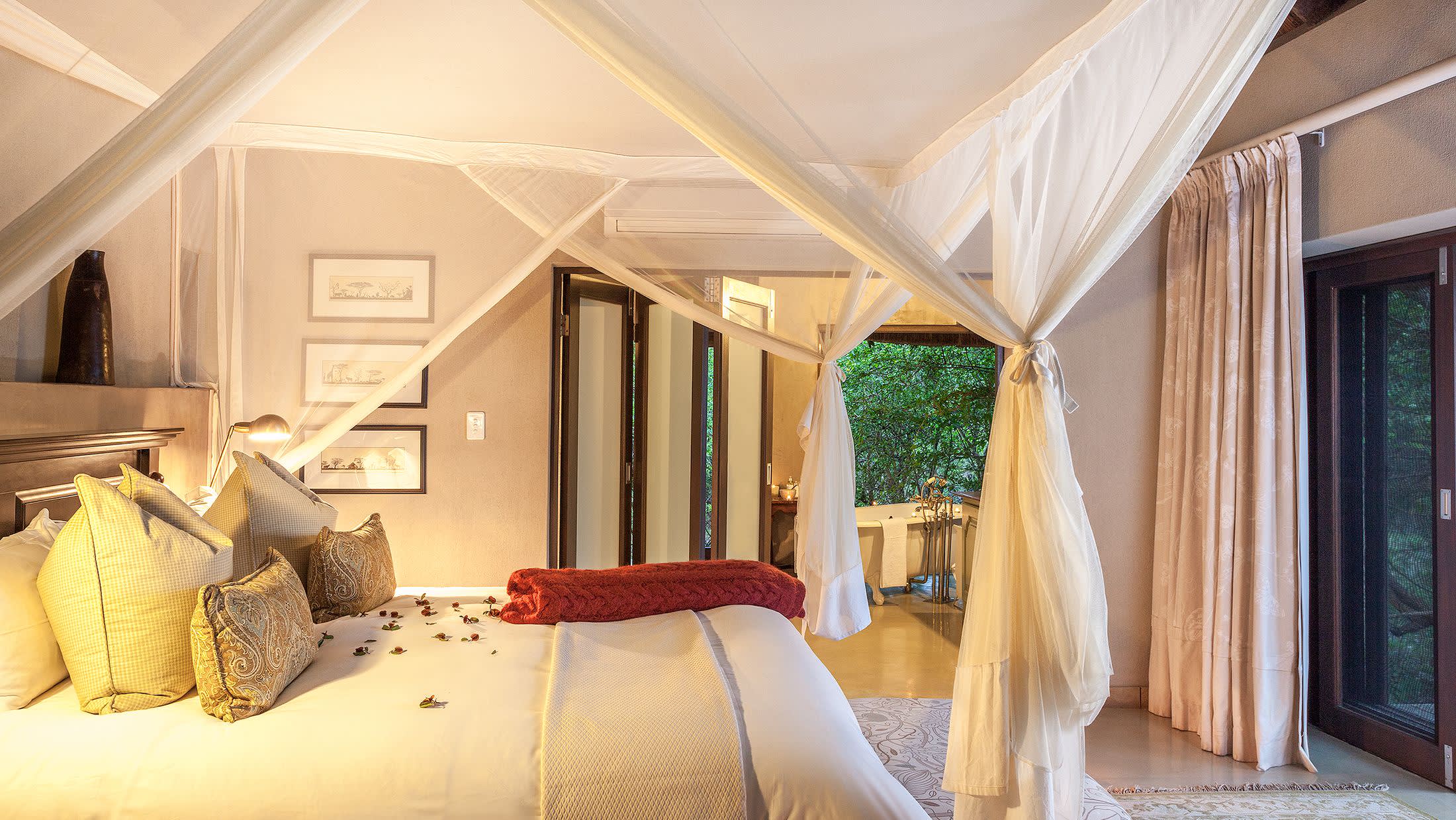 a bedroom with a bed and a chair in a room