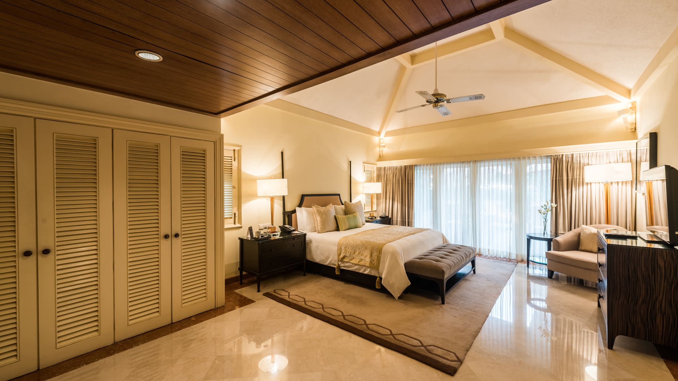 a bedroom with a bed and desk in a room