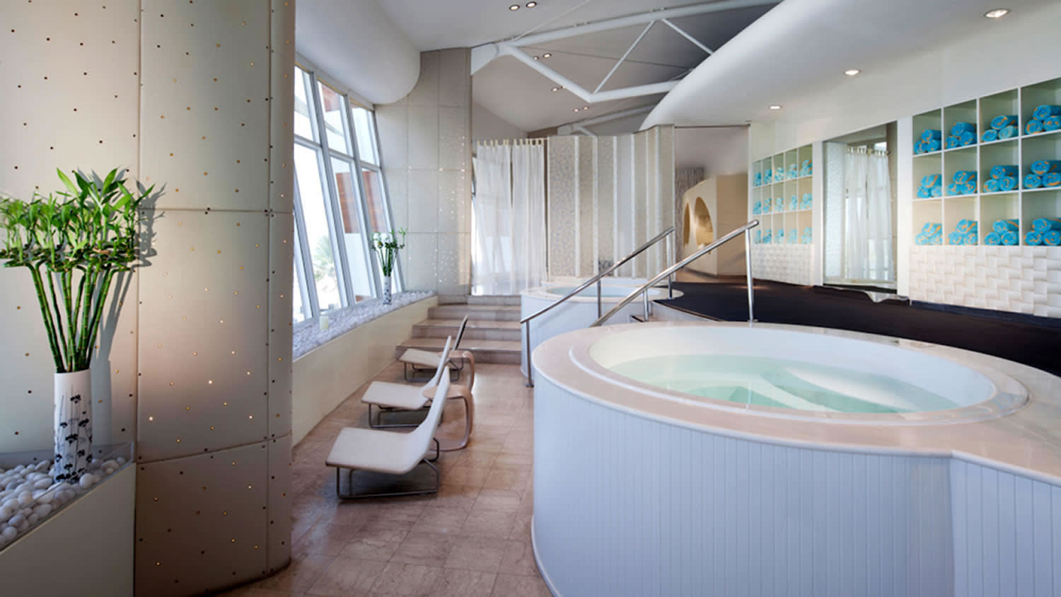 a large white tub next to a window