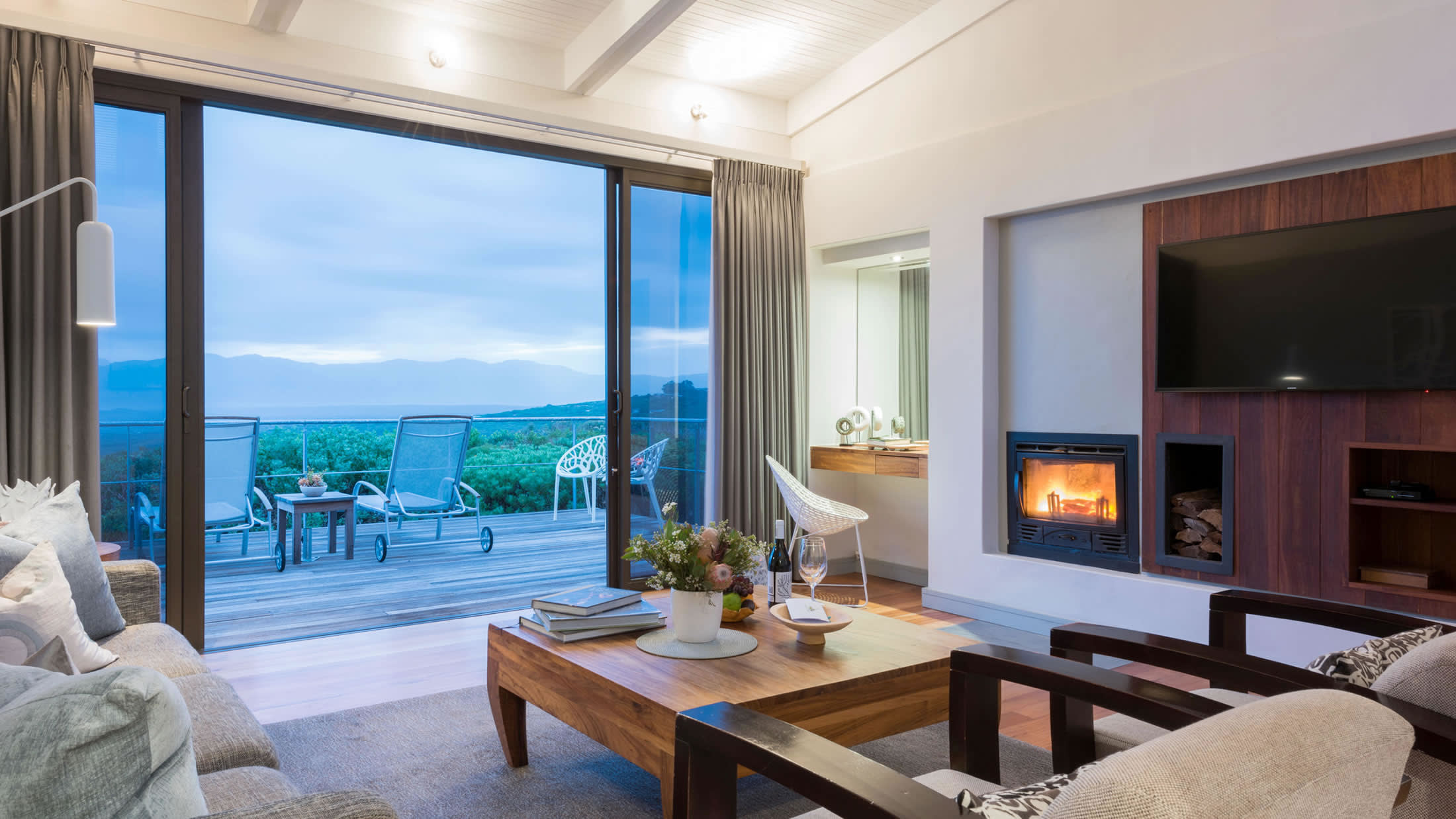 a view of a living room filled with furniture and a large window